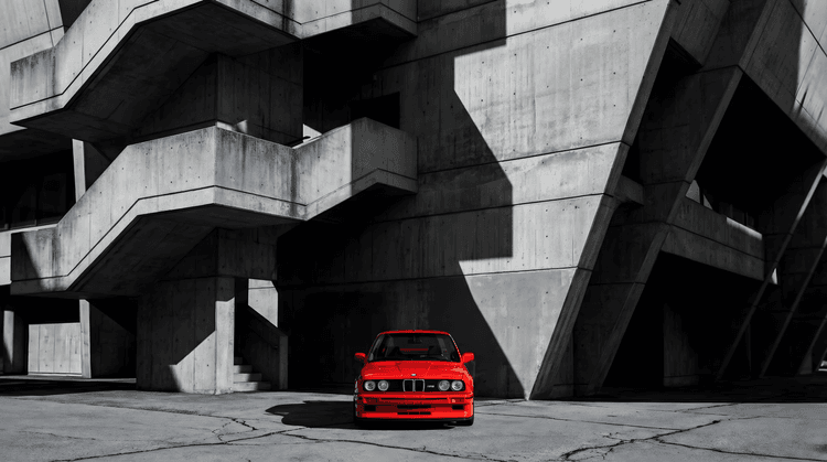 Crimson Icon: BMW E30 M3 in Brutalist Shadow